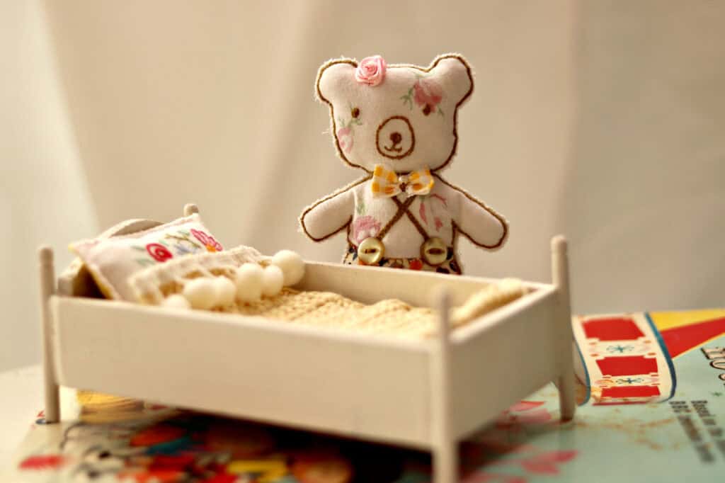 tiny stuffed bear and handmade bed